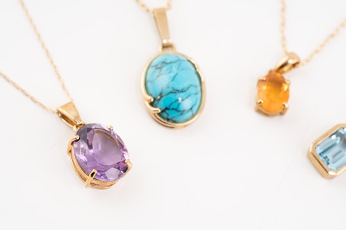 Lot 170 - A group of seven gem-set pendants on chain;...