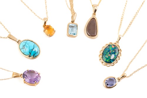 Lot 170 - A group of seven gem-set pendants on chain;...