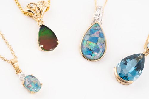 Lot 49 - Six gem-set drop pendants on chains; including...