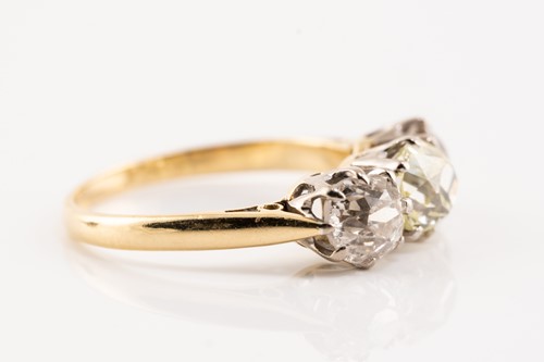 Lot 30 - An old-cut diamond trilogy ring, claw-set in...
