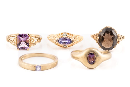 Lot 185 - Five gem-set dress rings in gold; including a...