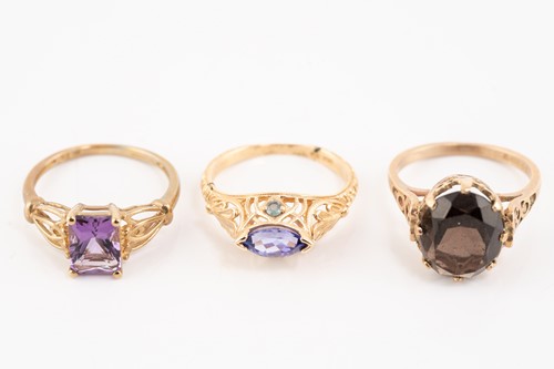 Lot 185 - Five gem-set dress rings in gold; including a...