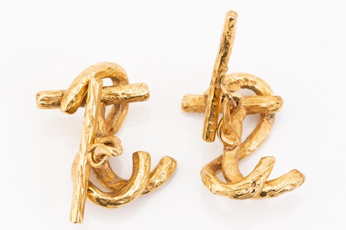 Lot 217 - A pair of yellow metal cypher cufflinks, each...