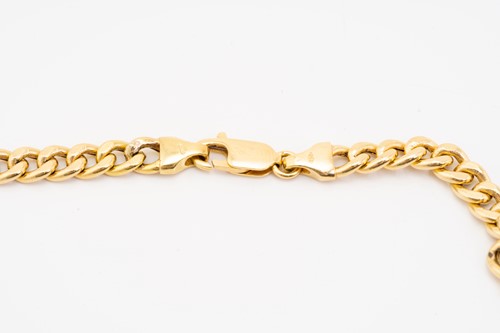Lot 121 - A yellow metal flat curb link chain, fastens...
