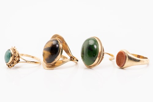 Lot 115 - Four hard stone rings; including a 9ct yellow...