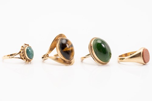 Lot 115 - Four hard stone rings; including a 9ct yellow...