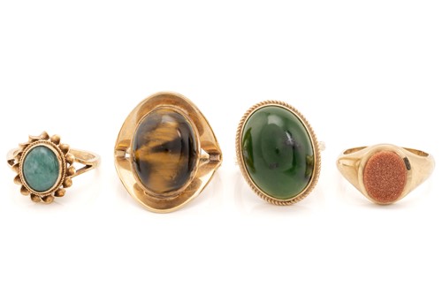 Lot 115 - Four hard stone rings; including a 9ct yellow...