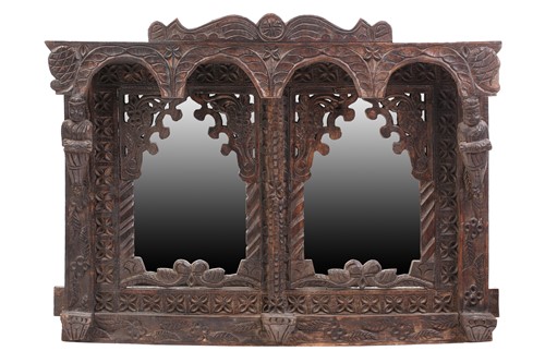 Lot 128 - An Indian rustic carved teakwood over mantle...