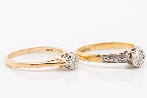 Lot 69 - Two single-stone diamond rings, featuring a...