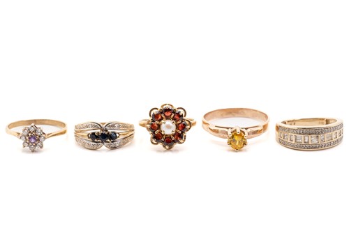 Lot 135 - Five gold rings; including a yellow metal and...