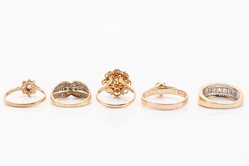 Lot 135 - Five gold rings; including a yellow metal and...