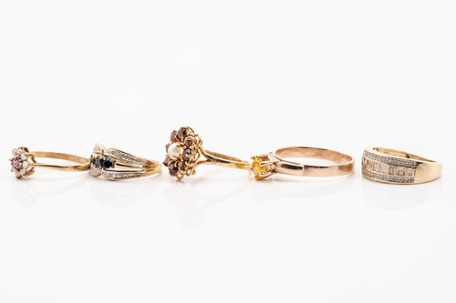 Lot 135 - Five gold rings; including a yellow metal and...