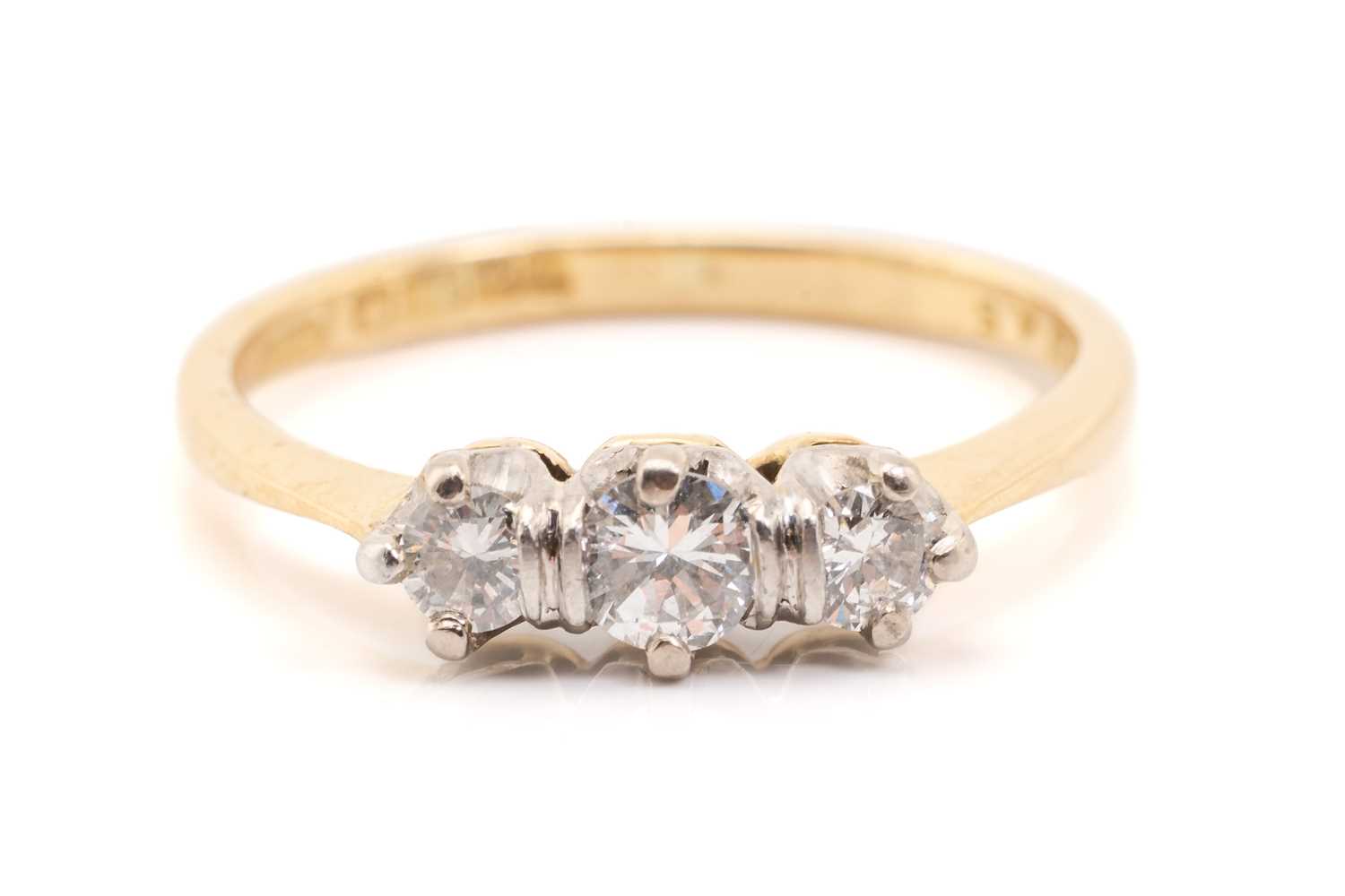 Lot 157 - A yellow gold and diamond three stone half...