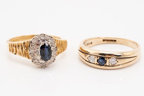 Lot 129 - A sapphire and diamond cluster rings, the oval...