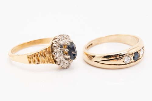 Lot 129 - A sapphire and diamond cluster rings, the oval...