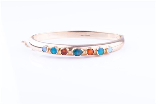 Lot 516 - A 9ct yellow gold and opal bracelet the hinged...