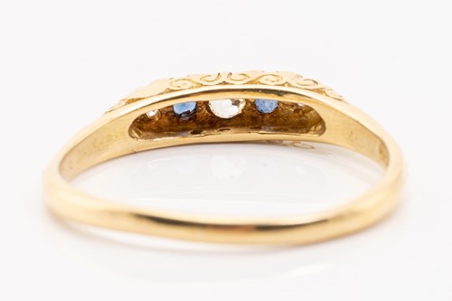 Lot 132 - An 18ct yellow gold, sapphire and diamond half-...
