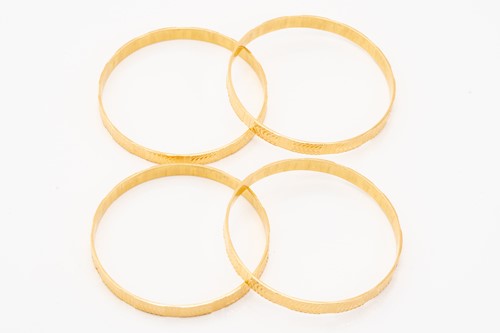 Lot 5 - A suite of four bangle bracelets, decorated in...