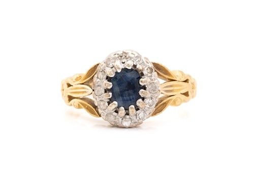 Lot 214 - A sapphire and diamond entourage ring in 18ct...