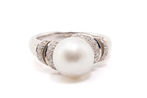 Lot 235 - A white metal, single stone pearl and diamond...