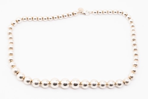 Lot 127 - Tiffany & Co. A silver graduated ball necklace,...