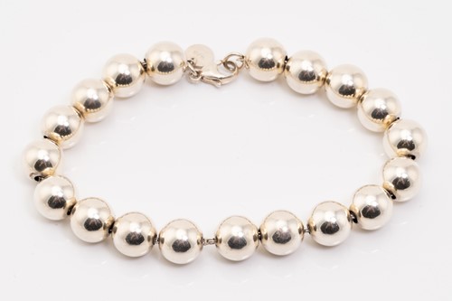 Lot 127 - Tiffany & Co. A silver graduated ball necklace,...