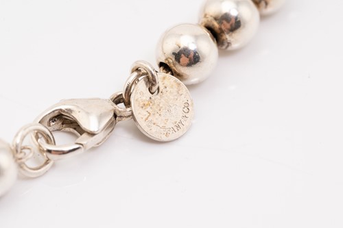 Lot 127 - Tiffany & Co. A silver graduated ball necklace,...