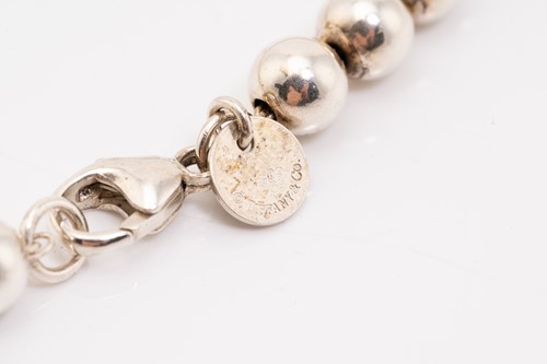 Lot 127 - Tiffany & Co. A silver graduated ball necklace,...