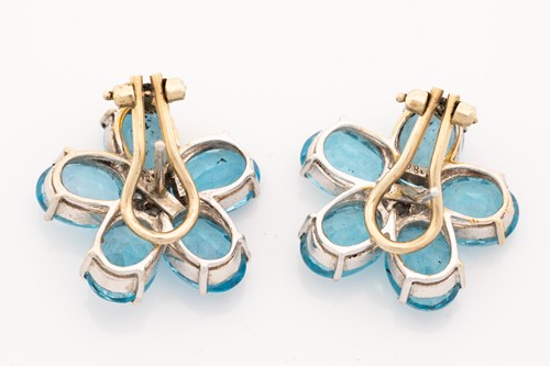 Lot 124 - A pair of flowerhead earrings set with topaz...