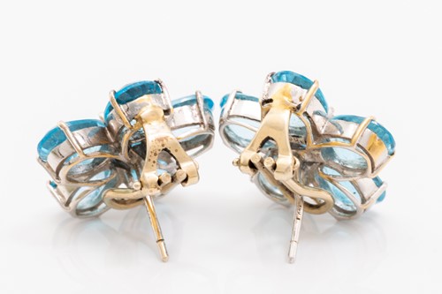 Lot 124 - A pair of flowerhead earrings set with topaz...