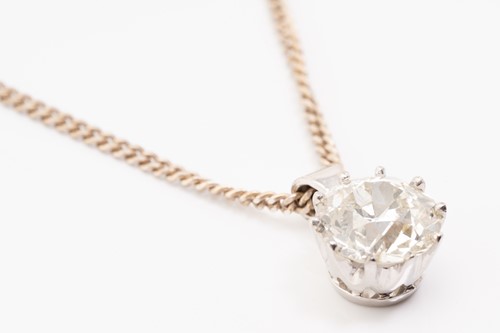 Lot 290 - A solitaire diamond pendant, the Old European...