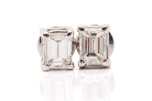 Lot 66 - A pair of diamond stud earrings, each set with...