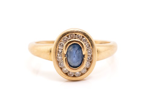 Lot 138 - A yellow metal, sapphire and diamond halo ring,...