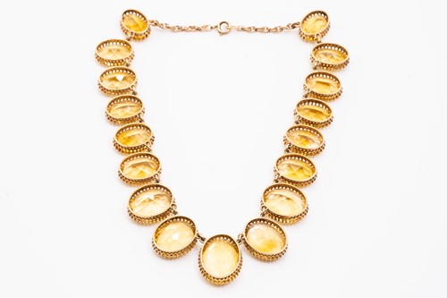 Lot 197 - A yellow metal and citrine rivière necklace,...