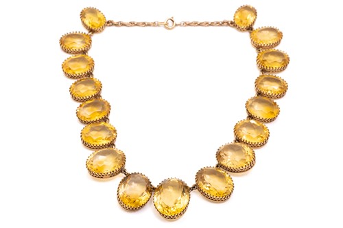 Lot 197 - A yellow metal and citrine rivière necklace,...