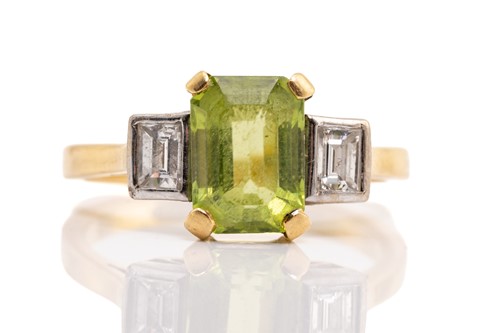 Lot 261 - A peridot and diamond trilogy ring in 18ct...