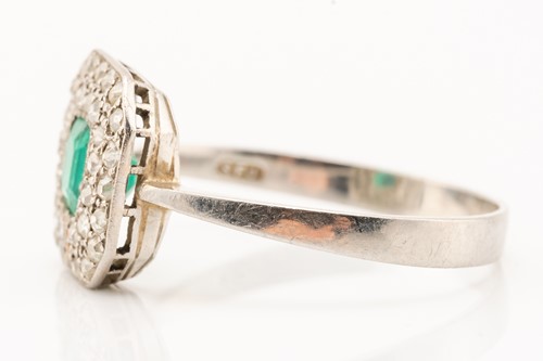 Lot 51 - An emerald and diamond cluster ring in...