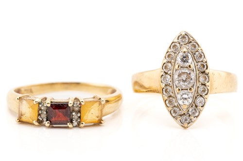 Lot 145 - A citrine and garnet three stone half hoop...