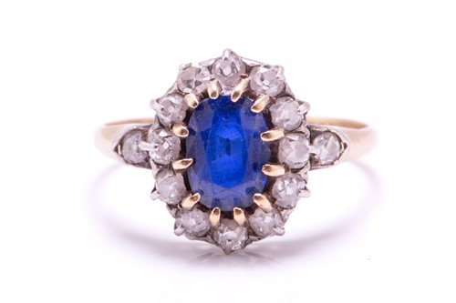 Lot 256 - A sapphire and diamond cluster ring; the oval...