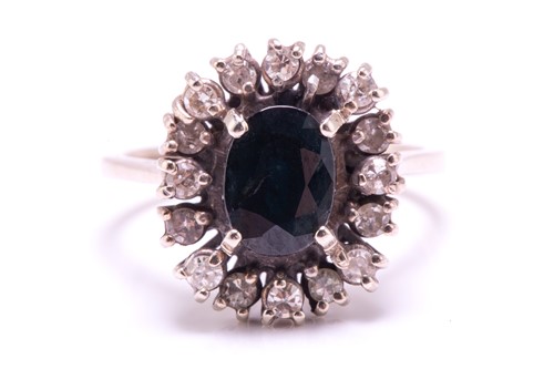 Lot 164 - A sapphire and diamond cluster ring, centred...