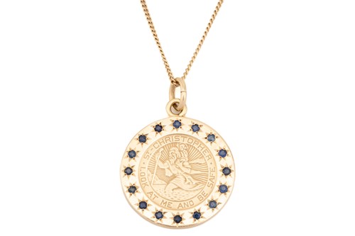 Lot 26 - A St. Christopher medal with sapphire surround...