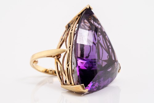 Lot 8 - A large amethyst cocktail ring, featuring a...