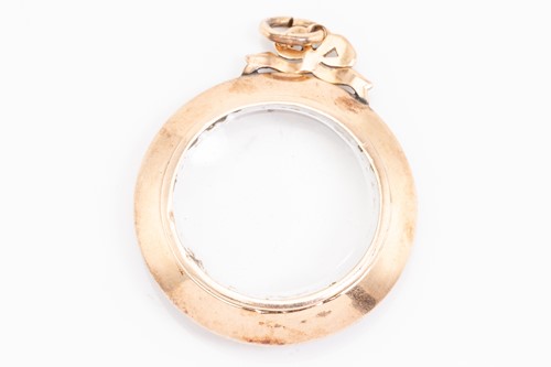 Lot 105 - A mourning locket pendant, the circular locket...