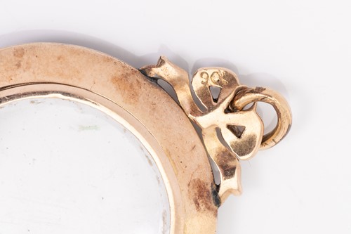 Lot 105 - A mourning locket pendant, the circular locket...