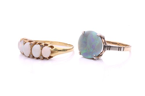 Lot 34 - Two precious opal dress rings; to include a...