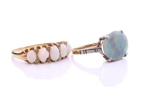 Lot 34 - Two precious opal dress rings; to include a...