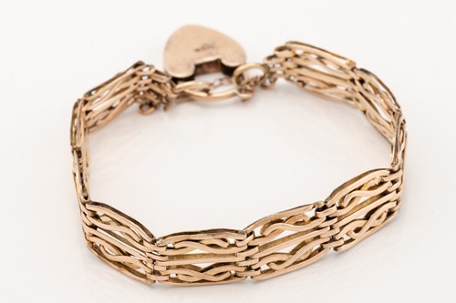 Lot 221 - A rose gold knot bangle; the hinged hollow...