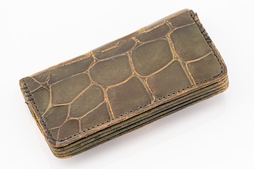 Lot 33 - A green crocodile wallet with 9 carat rose...