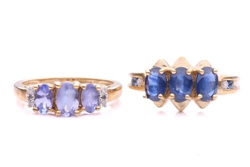 Lot 136 - Two gem-set three stones dress rings in 9ct...