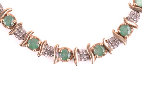 Lot 50 - An emerald and diamond line bracelet in 9ct...